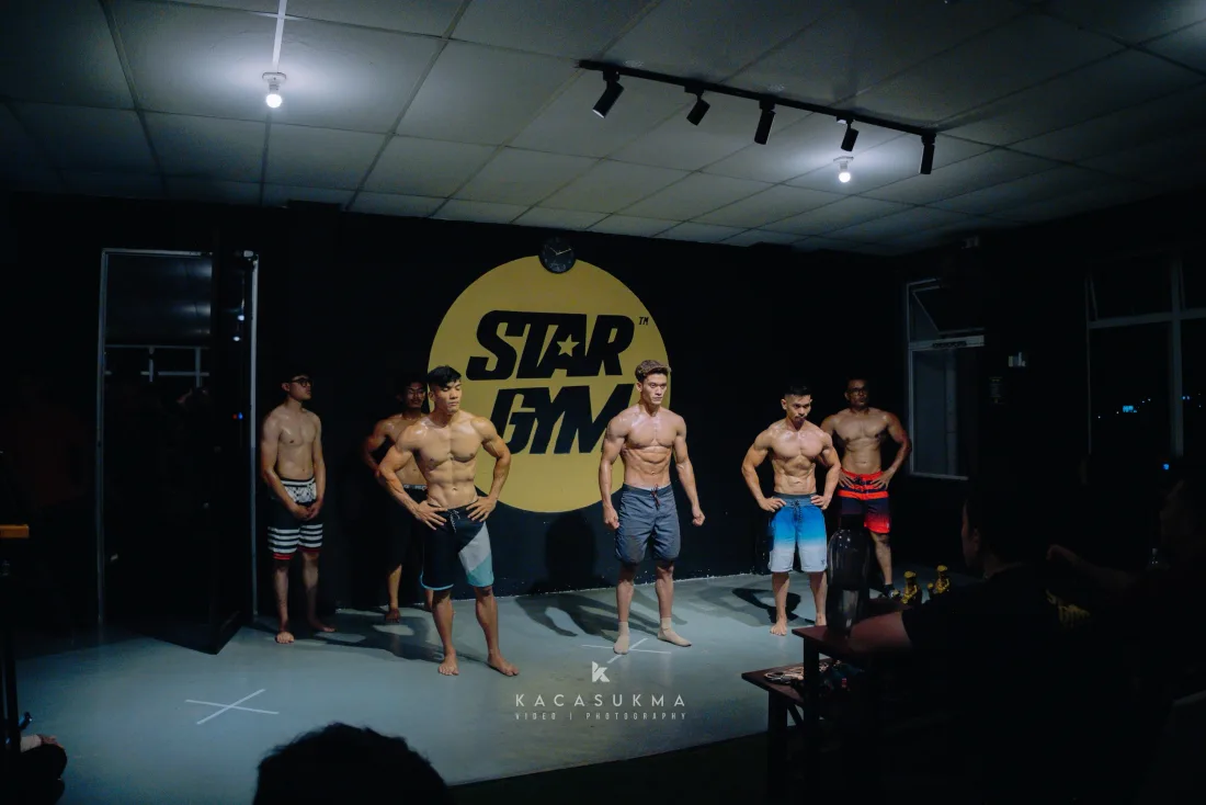 Group of competitors posing together on stage